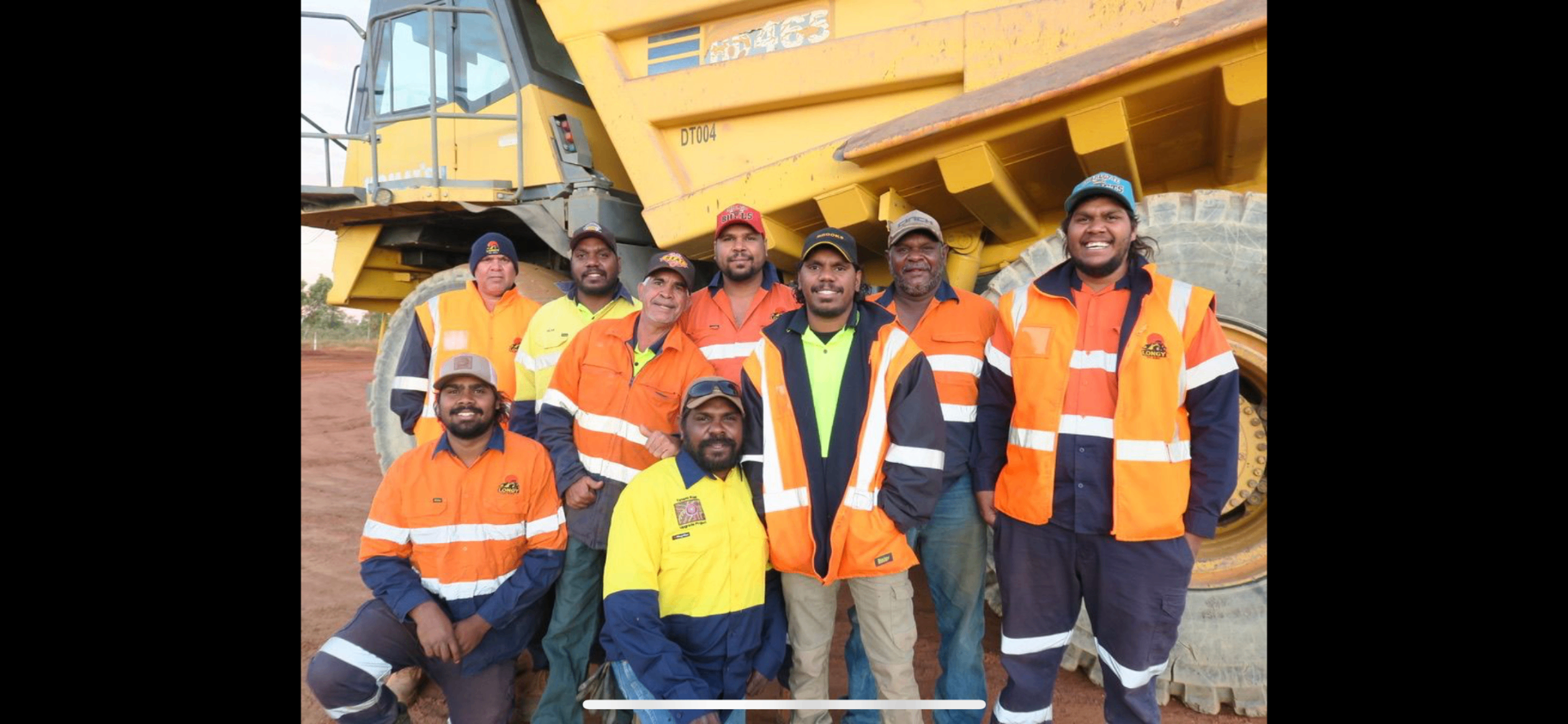 Aboriginal crew on a Kimberley mine site standing in front of a haul truck